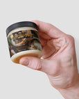 Organic Raw Shea Butter jar in hand, 4 oz container, vegan and cruelty-free skincare product.