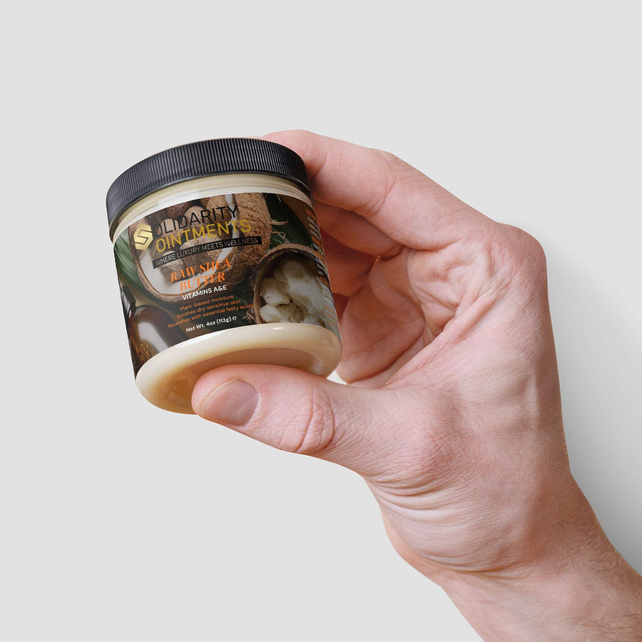 Organic Raw Shea Butter jar in hand, 4 oz container, vegan and cruelty-free skincare product.