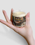 Hand holding a jar of raw shea butter for moisturizing skincare.