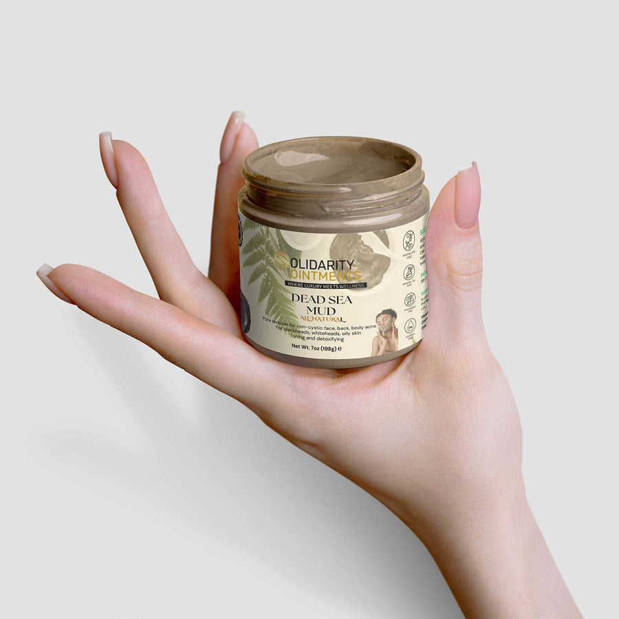 Dead Sea mud jar held in hand, natural skincare product, mineral-rich formula, spa-quality experience.