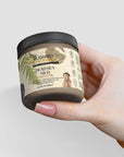 Dead Sea Mud jar held in hand, natural skincare remedy rich in minerals for rejuvenating and purifying skin.