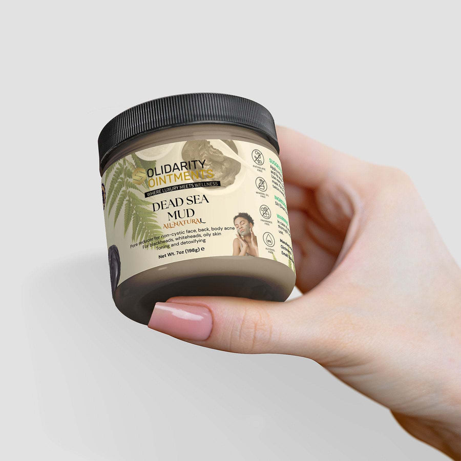 Dead Sea Mud jar held in hand, natural skincare remedy rich in minerals for rejuvenating and purifying skin.