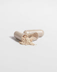 Cordyceps mushroom capsules with powder contents on white background.