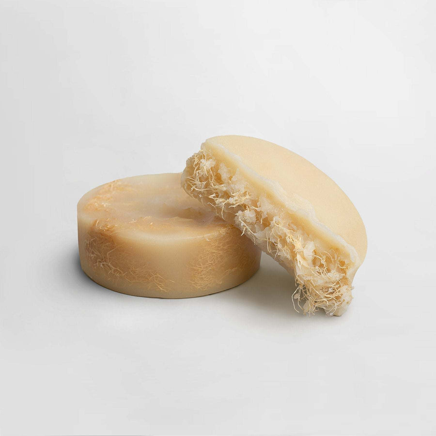 Exfoliating luffa soap bar with natural fibers for silky smooth skin.