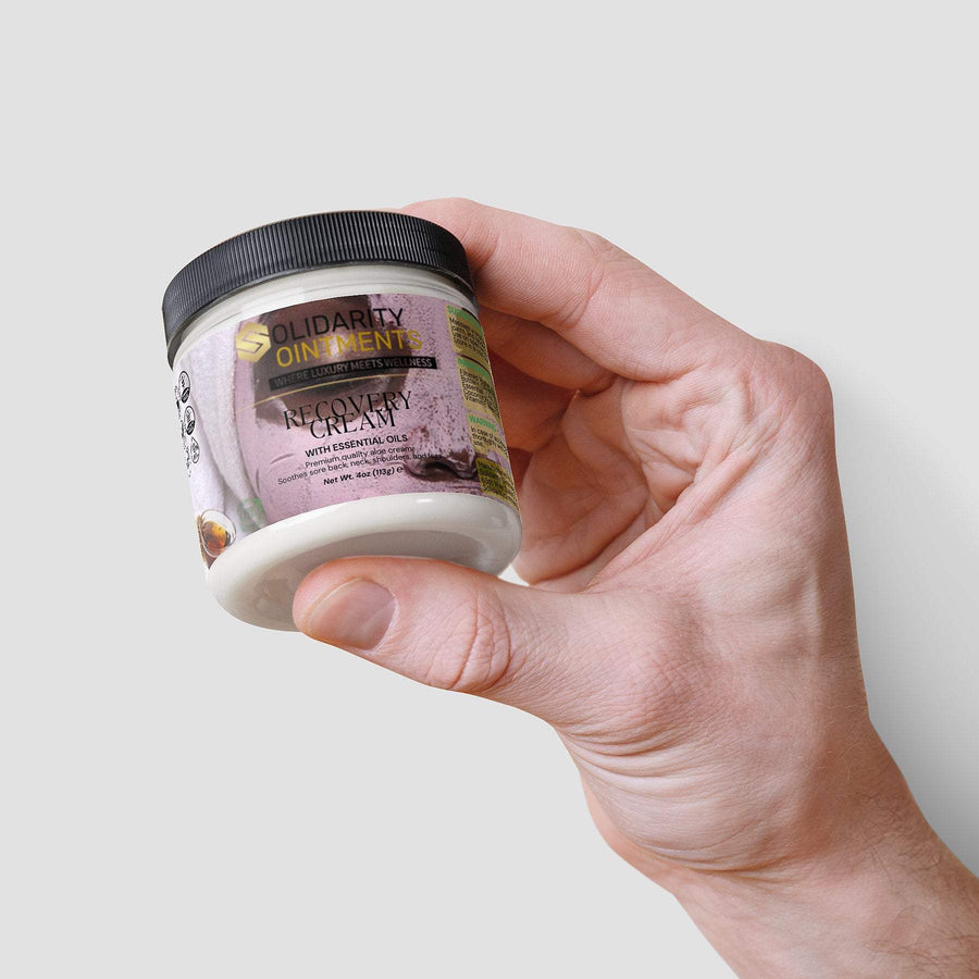 Recovery cream jar held in hand, premium skincare with aloe and essential oils for moisturizing and hydration.