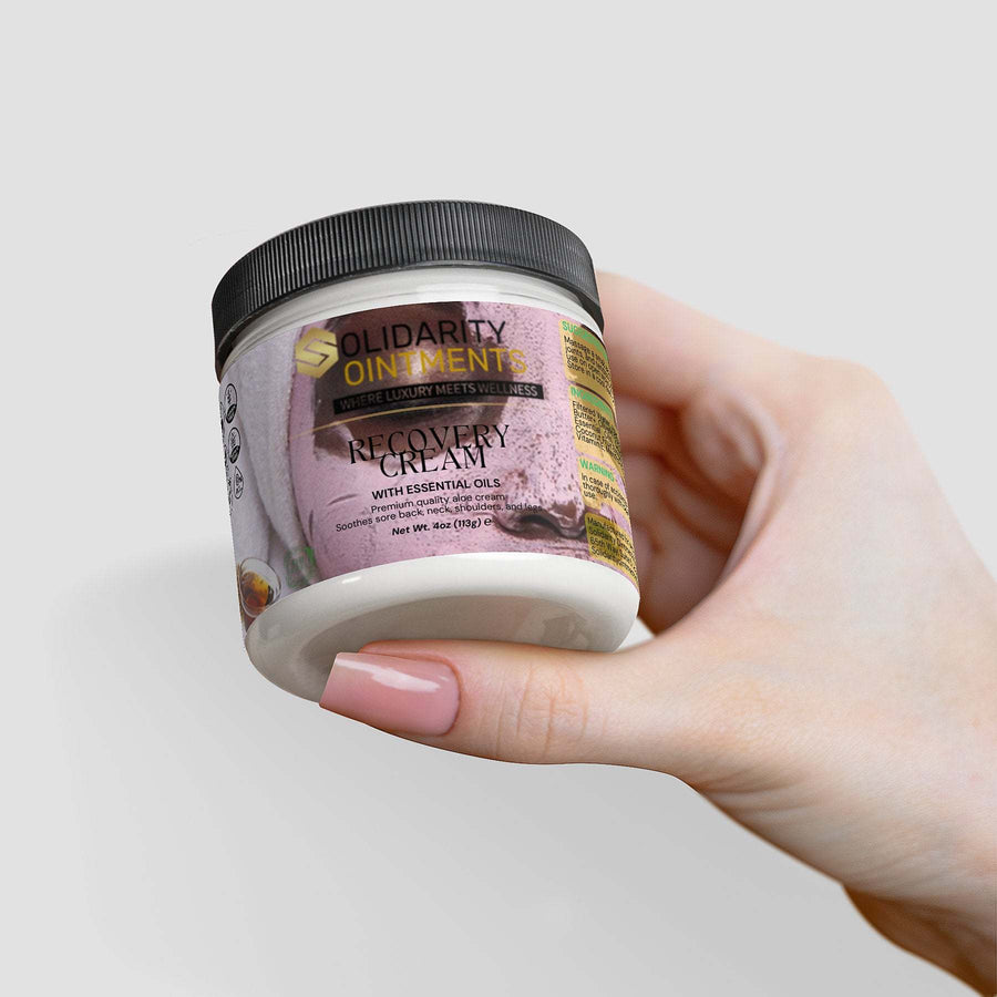 Recovery cream jar held by a person, featuring premium skincare ingredients for hydration and comfort.