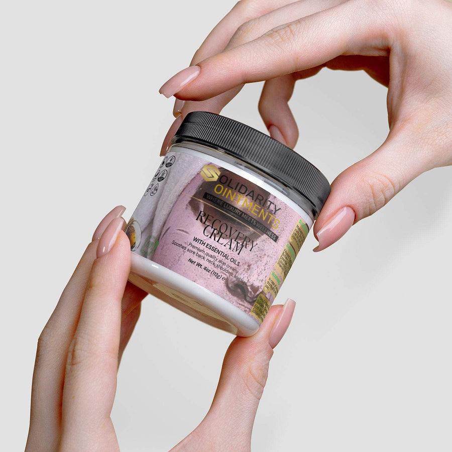 Recovery Cream in a jar being held, premium skincare with aloe and essential oils for hydration and relaxation.