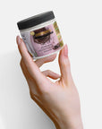 Recovery cream jar held in hand, emphasizing hydration and comfort.