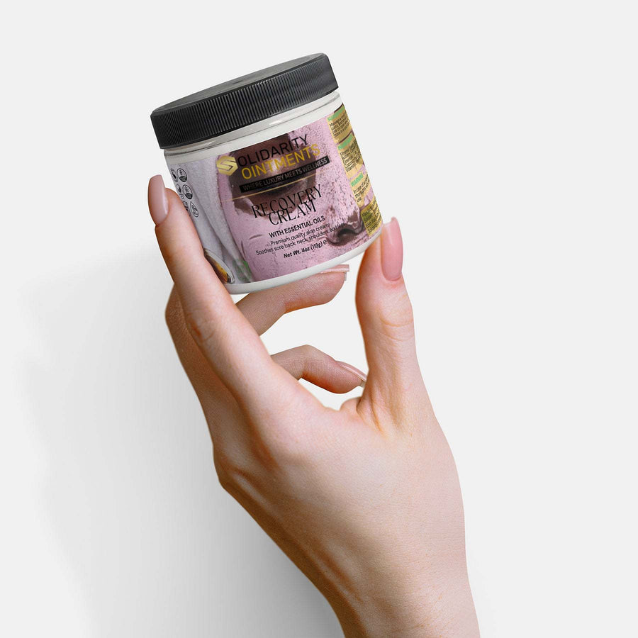 Recovery cream jar held in hand, emphasizing hydration and comfort.